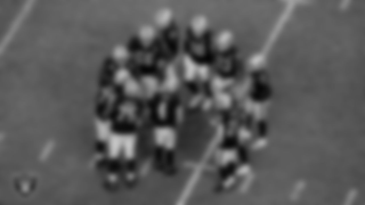 The Las Vegas Raiders offense huddles during the regular season game against the Denver Broncos at Allegiant Stadium.