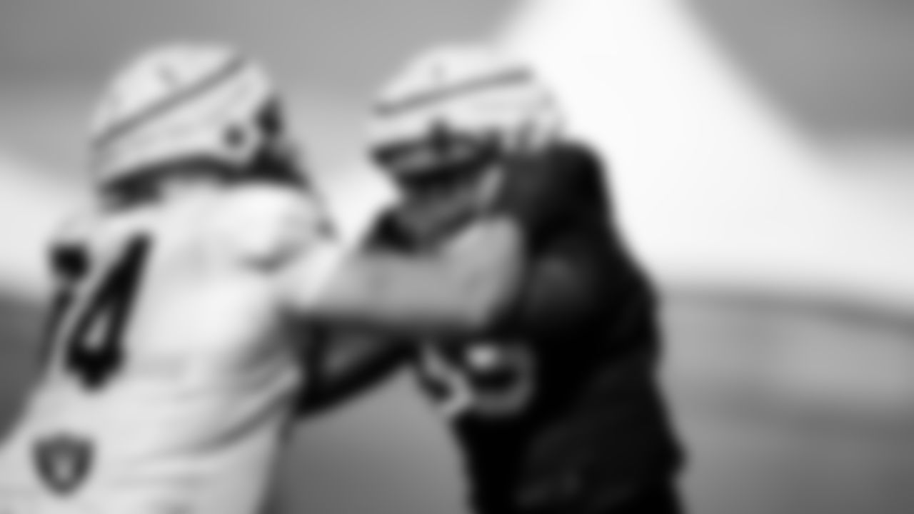 Las Vegas Raiders tackle Kolton Miller (74) and defensive end Chandler Jones (55) on the field for practice at 2022 Training Camp at Intermountain Healthcare Performance Center.