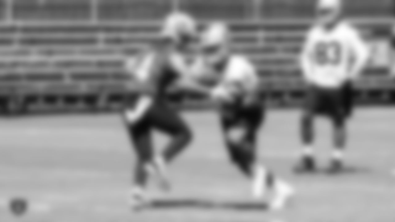 Oakland Raiders quarterback Derek Carr (4) and running back Chris Warren (34) on the field for practice at 2018 Pre-Training Camp at The Oakland Raiders Napa Valley Training Complex, Tuesday, July 24, 2018, in Napa, California.