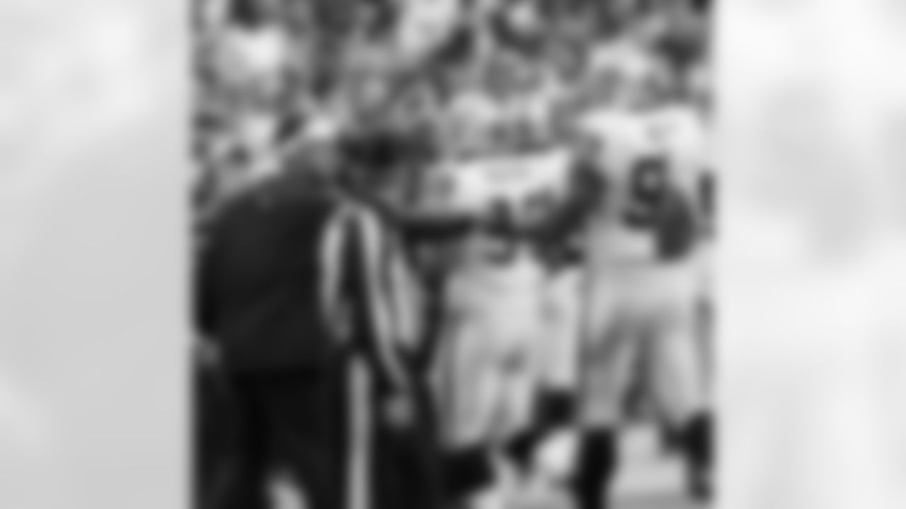 Head Coach Dennis Allen congratulates DT Tommy Kelly as he comes to the sideline.