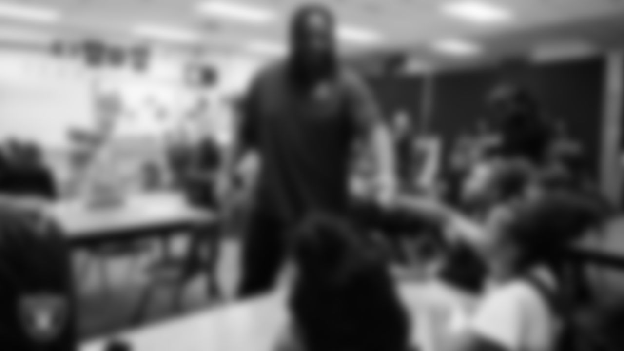 Las Vegas Raiders tackle Jalen McKenzie (73) meets members of the Hip Hop Entrepreneurship Program Academy at Grant Sawyer Middle School.