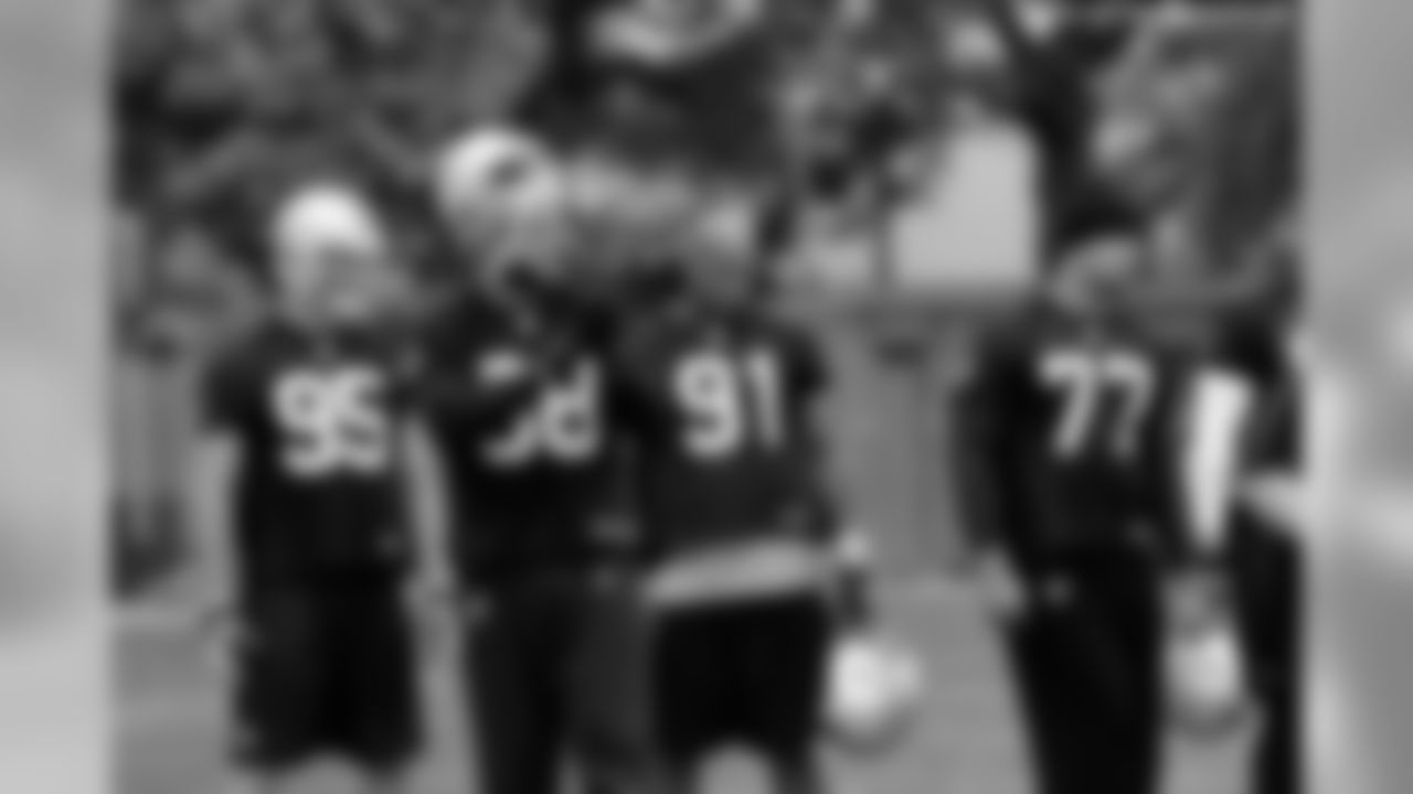 The defensive linemen watch a play.