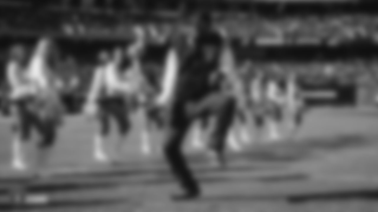 Oakland-native and rapper, MC Hammer, dances on the field before the regular season game against the Jacksonville Jaguars.