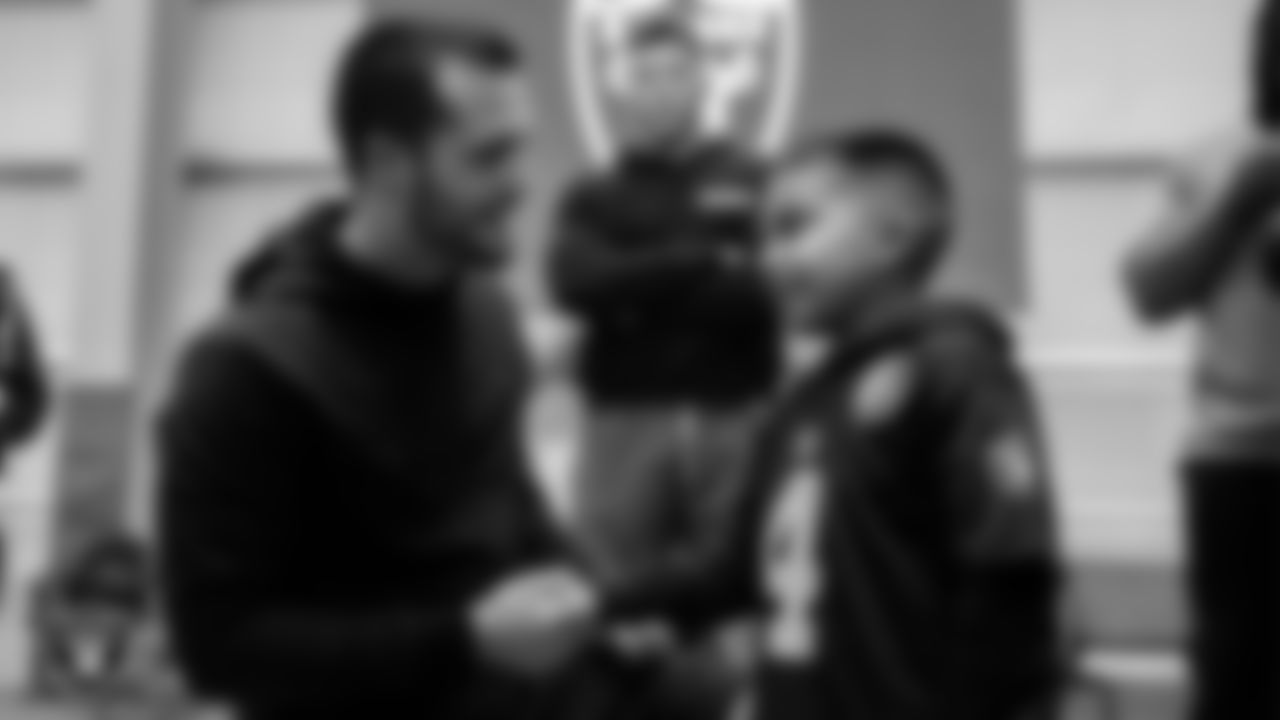 Eli Martinez from the Make-A-Wish Foundation meets quarterback Derek Carr (4) during a visit the Intermountain Healthcare Performance Center.