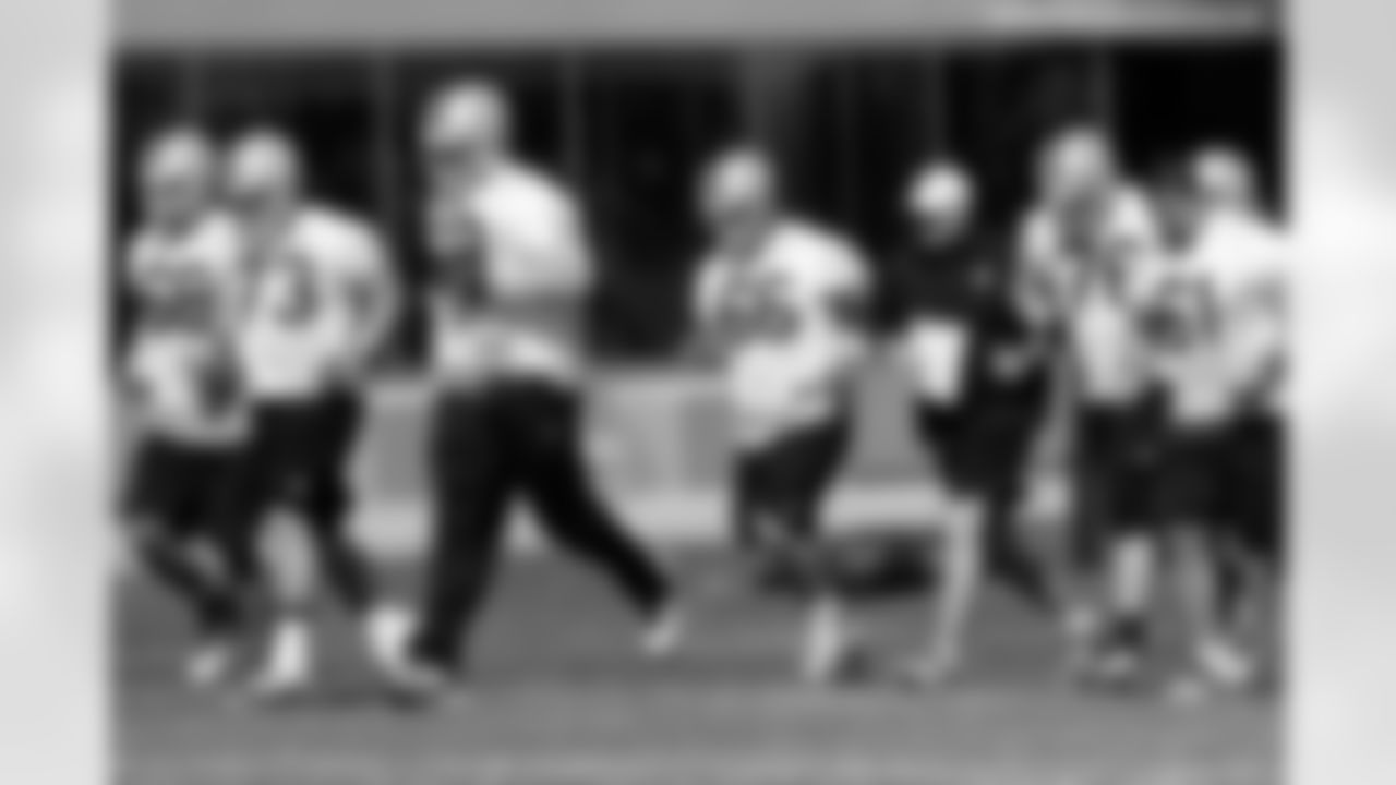 The offensive line runs to the field.