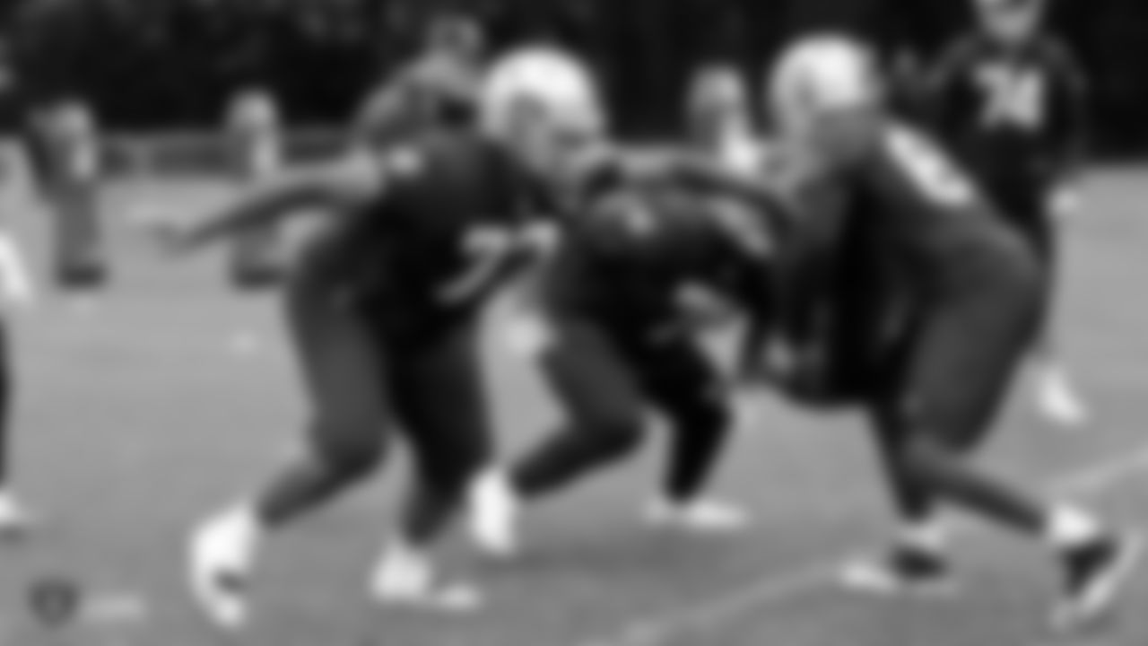 Raiders tackle Trent Brown (77), tackle Denzelle Good (71) and guard Lester Cotton Sr. (67) go through offensive line drills on the field during practice.