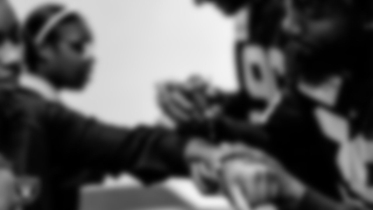 Las Vegas Raiders Nate Hobbs (39) signs an autograph for a community member during a Thanksgiving meal donation at the Pearson Community Center.
