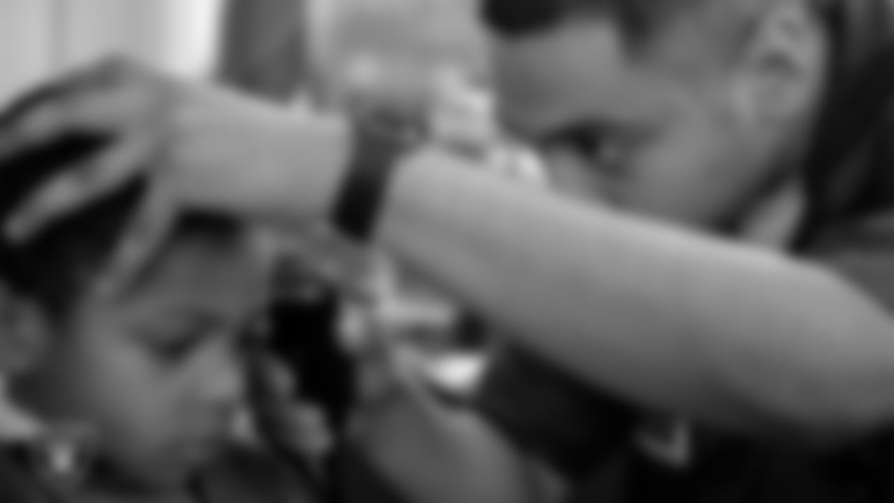 Students receive free haircuts and beautician services for the back to school season courtesy of the Las Vegas Raiders at Masterpiece Barber School.