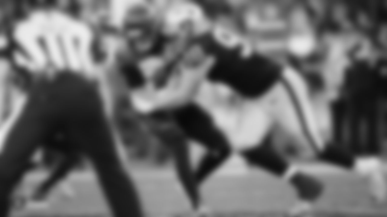 Raiders defensive end Maxx Crosby (98) sacks the quarterback during the regular season game against the Cincinnati Bengals.