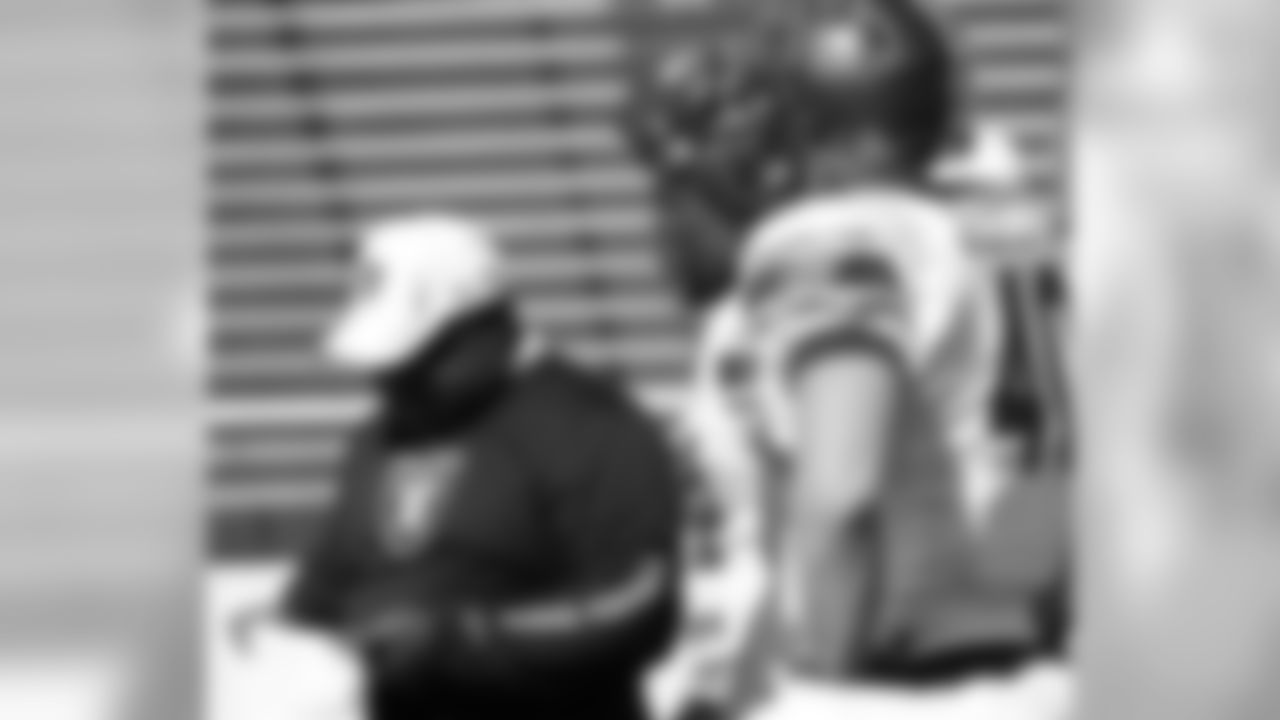Running backs coach Kelly Skipper takes a look at his notes.