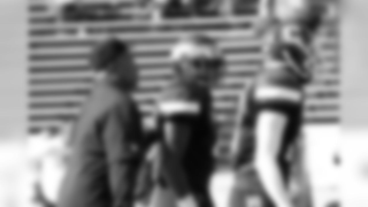 Defensive backs coach Johnnie Lynn passes on some information before the play.