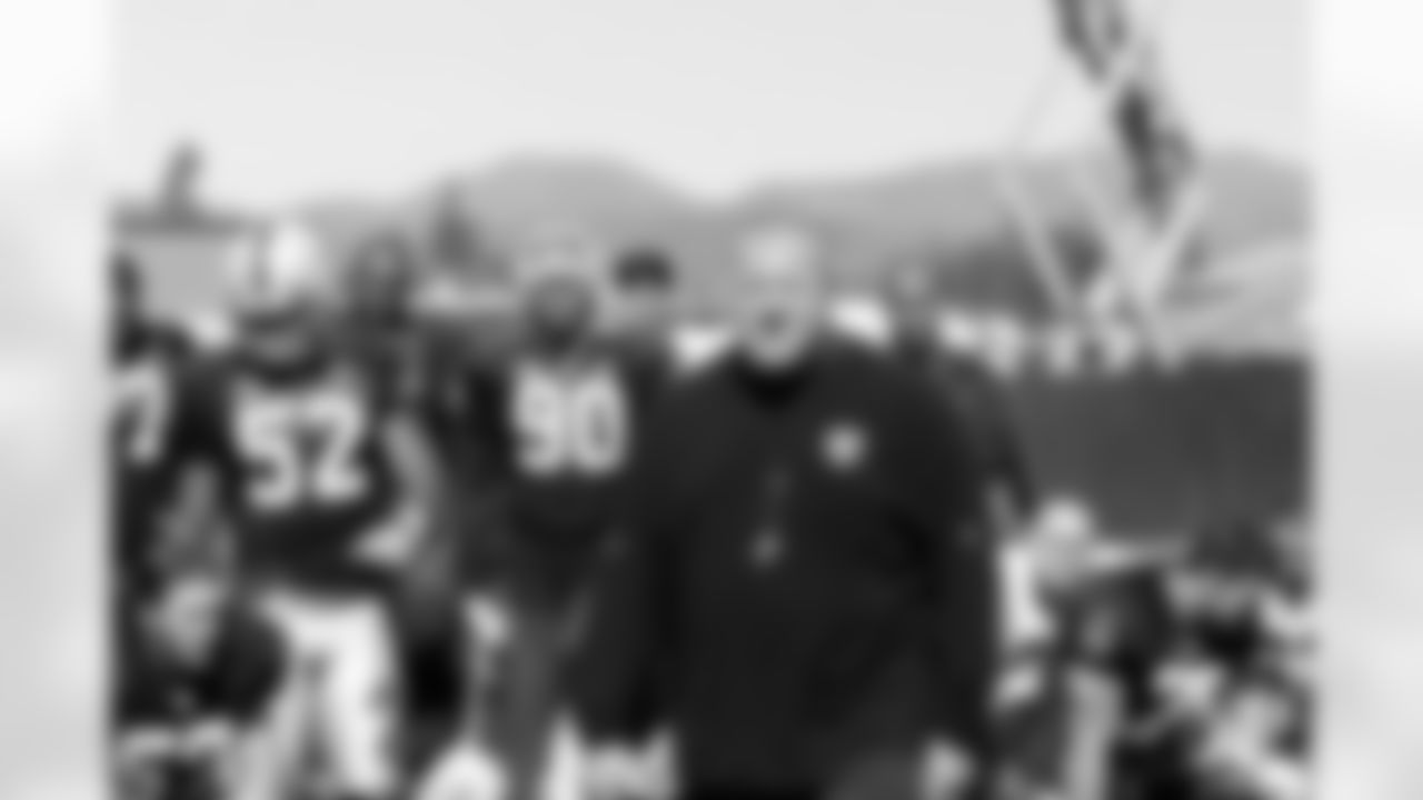 Head Coach Tom Cable addresses the team before the end of practice. Photo By Tony Gonzales
