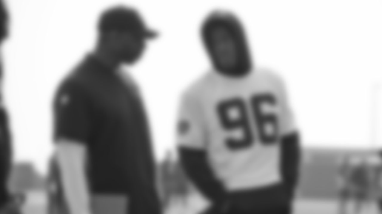 Oakland Raiders assistant defensive line coach Marco Coleman defensive end Kony Ealy (96) on the field for practice at the Oakland Raiders Practice Facility, Friday, November 9, 2018, in Alameda, California.