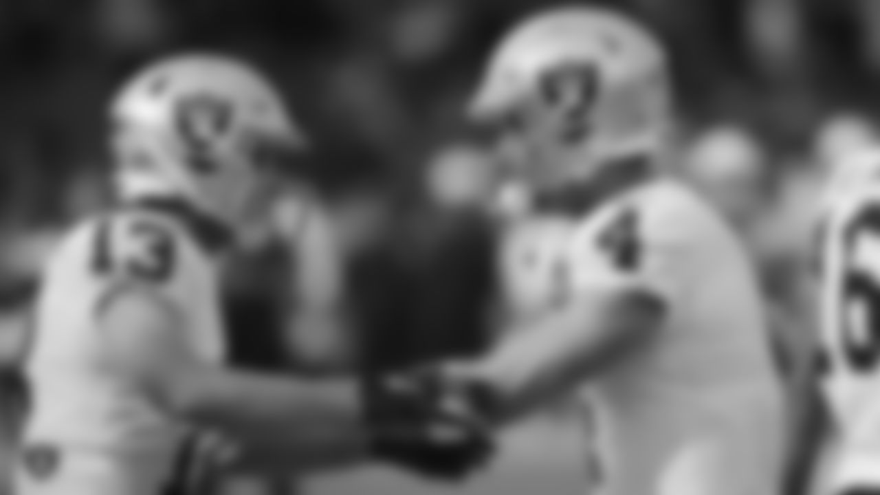 Raiders wide receiver Hunter Renfrow (13) celebrates with quarterback Derek Carr (4) after a 56-yard touchdown catch during the regular season game against the Los Angeles Chargers at ROKiT Field at Dignity Health Sports Park.