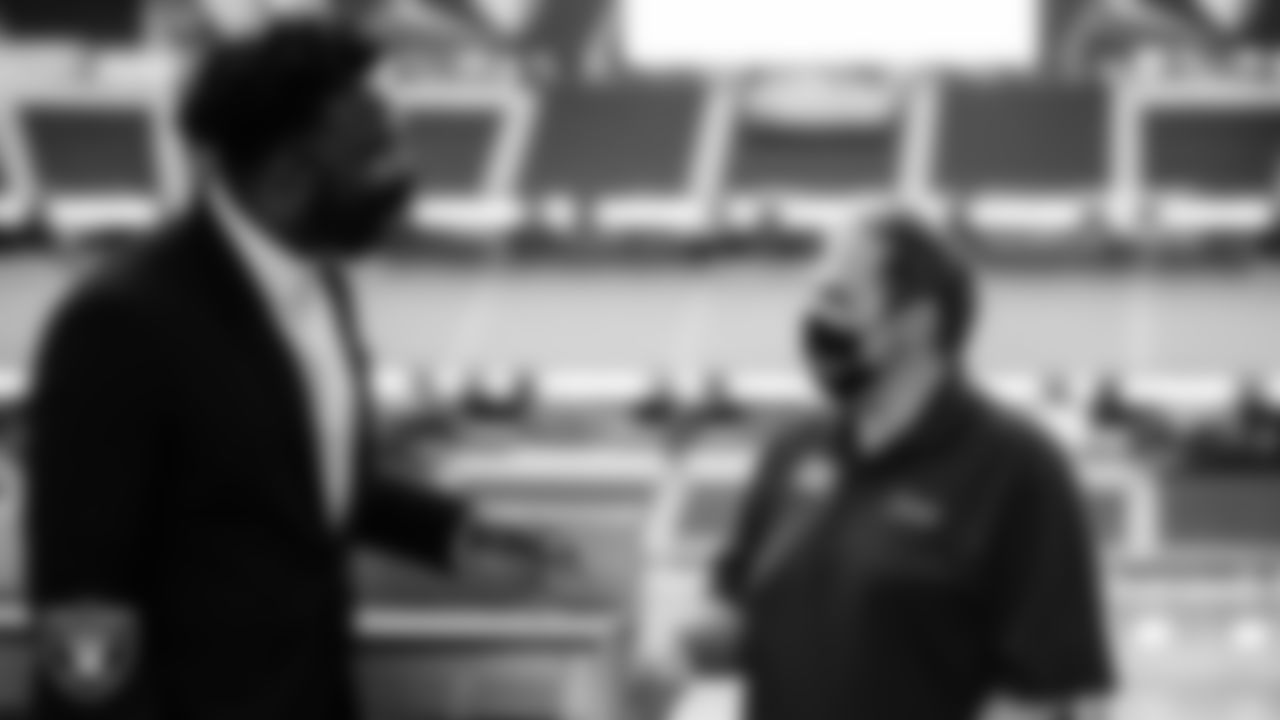 Las Vegas Raiders Senior Advisor Marcel Reece talks with an ambassador from Opportunity Village during the filming of a PSA and check presentation.
