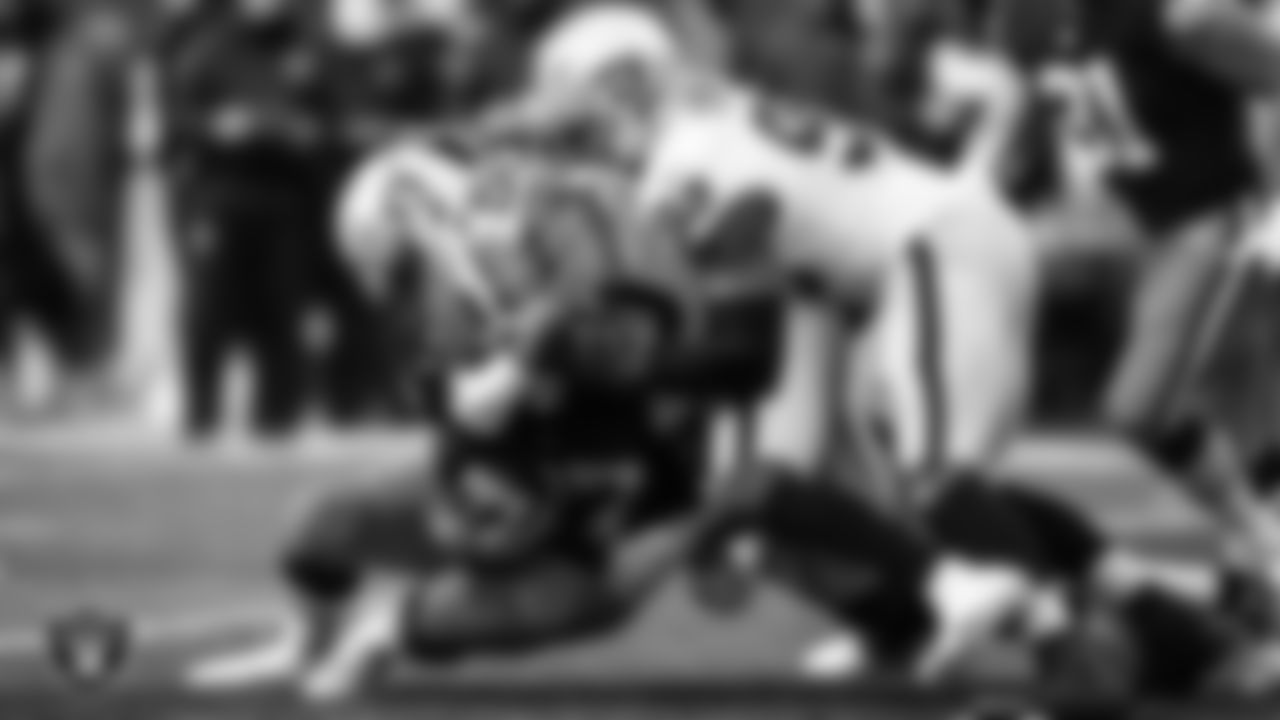 Las Vegas Raiders linebacker Nicholas Morrow (50) and defensive end Clelin Ferrell (96) make a tackle during the regular season away game against the Cleveland Browns.