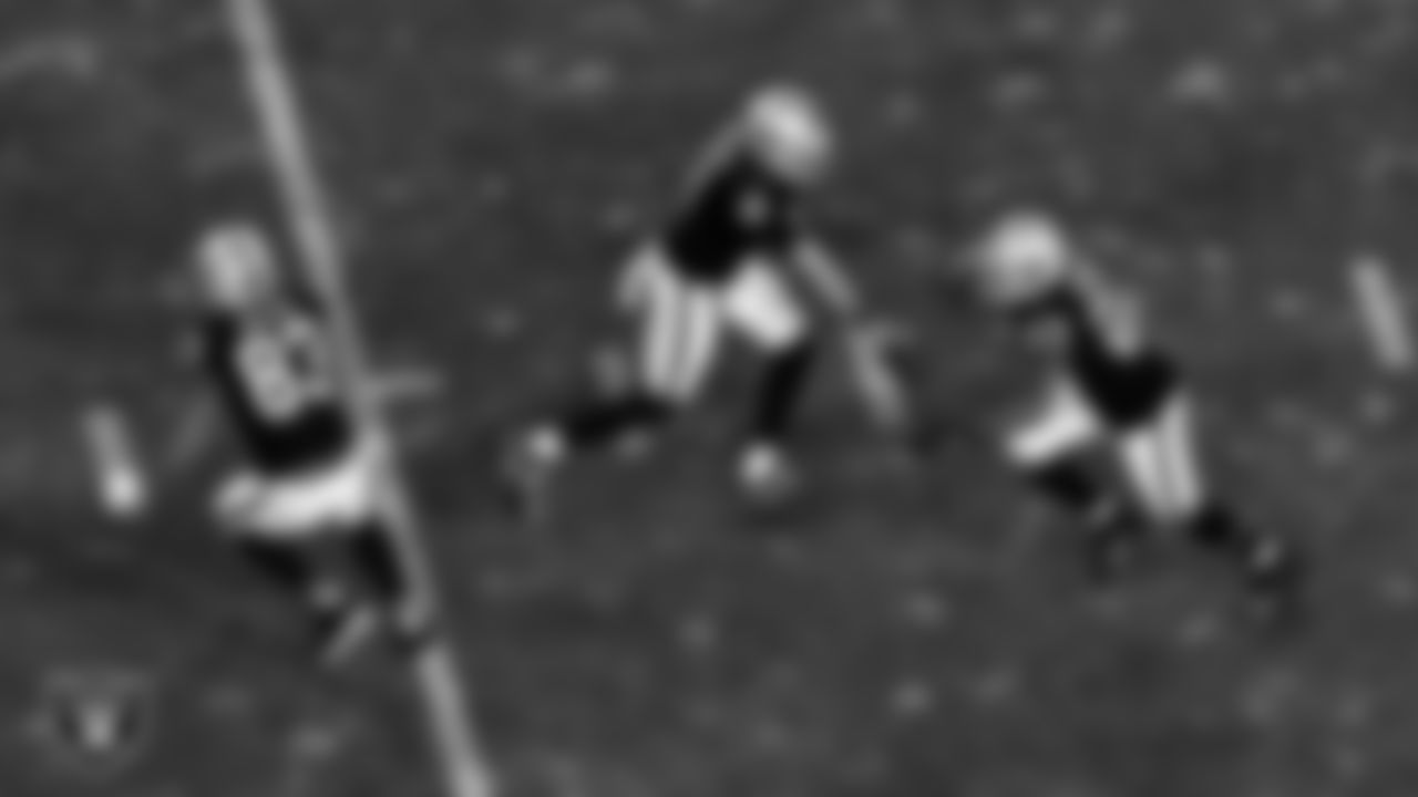 Las Vegas Raiders quarterback Marcus Mariota (8) hands the ball off to running back Devontae Booker (23) during the regular season home game against the Los Angeles Chargers.
