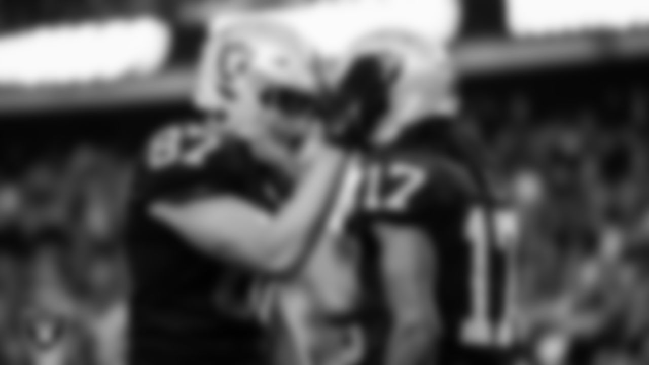 Las Vegas Raiders wide receiver Davante Adams (17) is congratulated by tight end Foster Moreau (87) after making a catch for a 48-yard touchdown during the regular season home game against the Indianapolis Colts at Allegiant Stadium.
