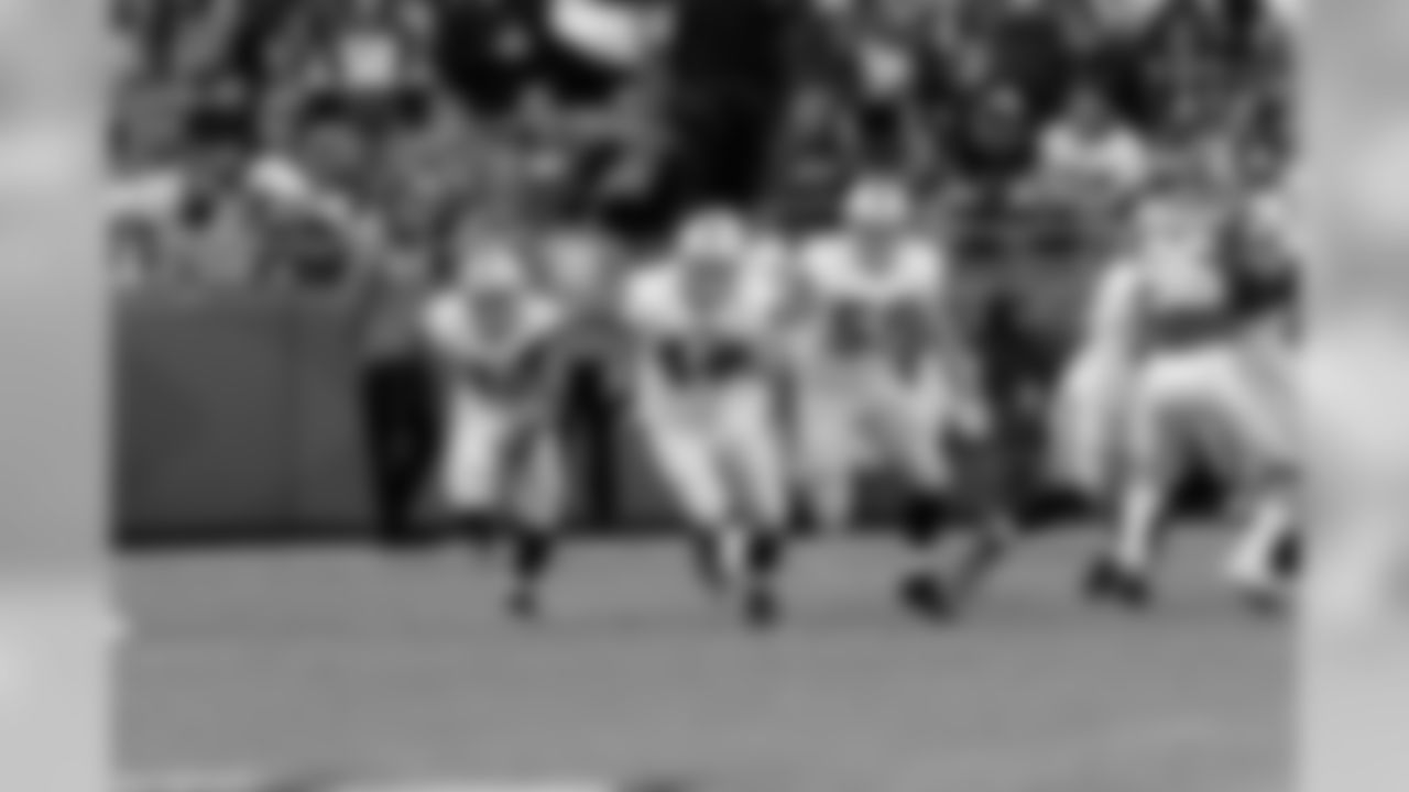 The Raiders special teams run down the field to stop the return man.