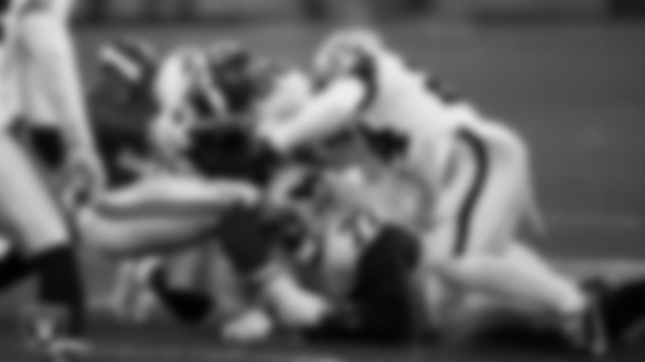 Las Vegas Raiders defensive end Clelin Ferrell (99), defensive tackle Quinton Jefferson (77) and safety Johnathan Abram (24) make a tackle during the regular season away game against the Kansas City Chiefs.