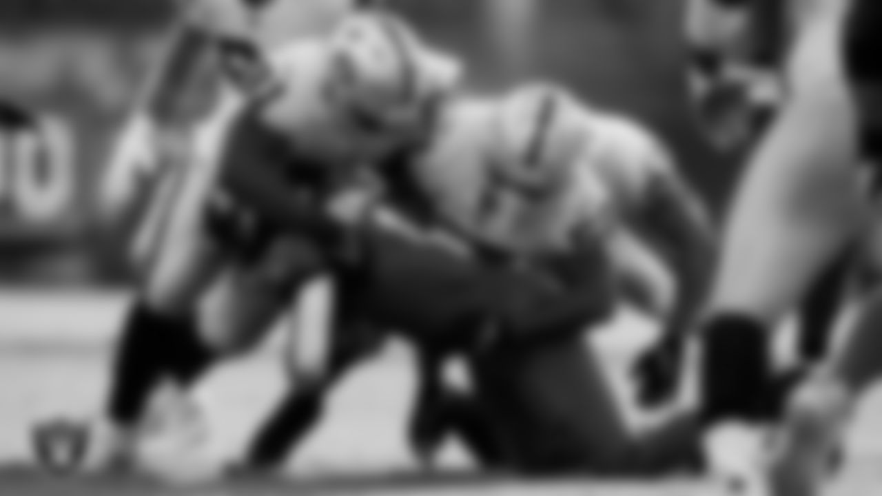 Las Vegas Raiders defensive tackle Bilal Nichols (91) and linebacker Denzel Perryman (52) make a tackle during the regular season away game against the Jacksonville Jaguars at TIAA Bank Field.