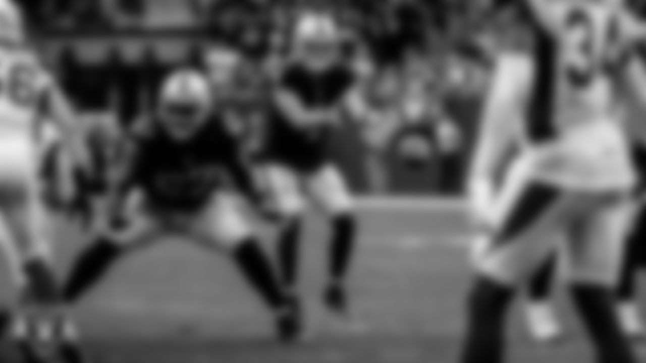 Las Vegas Raiders quarterback Derek Carr (4) receives the snap during the regular season home game against the Arizona Cardinals at Allegiant Stadium.