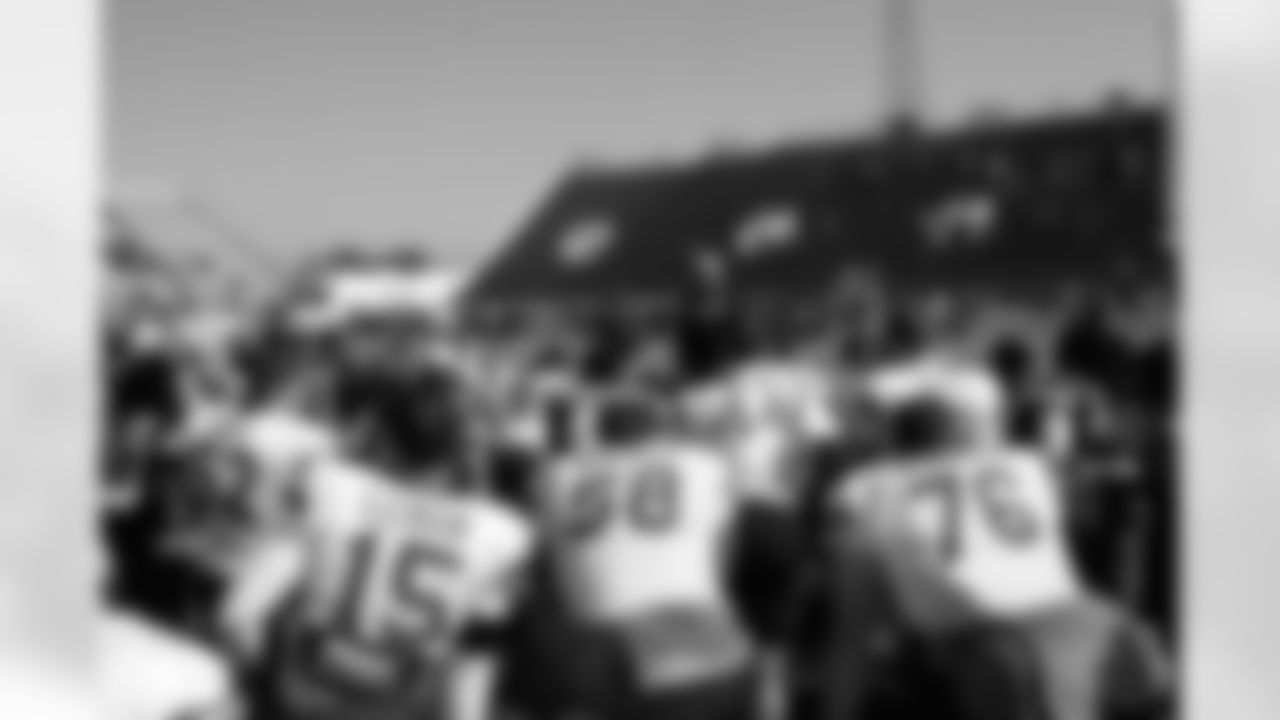 The players listen closely as Head Coach Dennis Allen speaks.