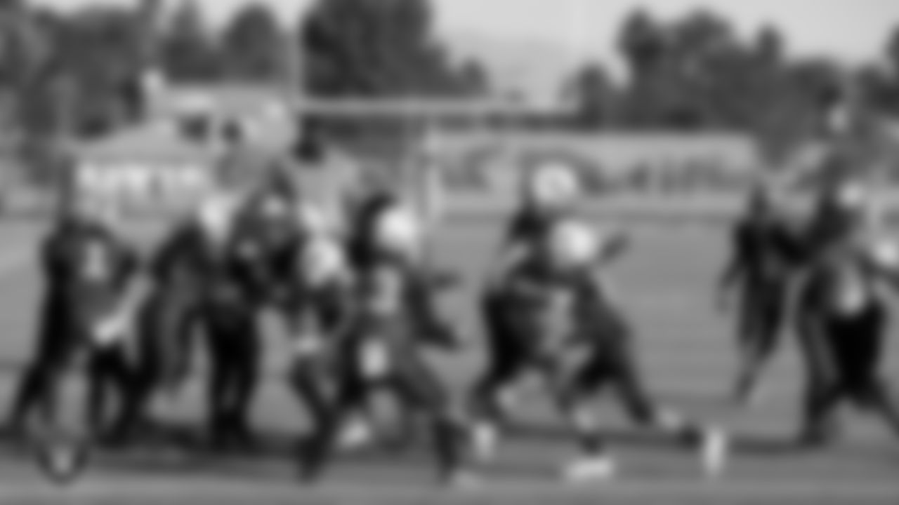 A Henderson Cowboys player hands the ball off to a teammate during a game against the Sin City Tritons at the American Youth Football & Cheer Regional Championships at Del Sol High School.