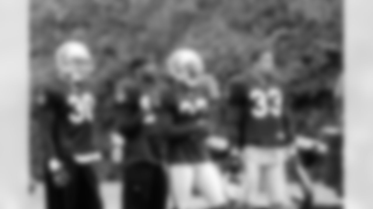 The Oakland Raider secondary looks on from the sideline. Photo By Tony Gonzales