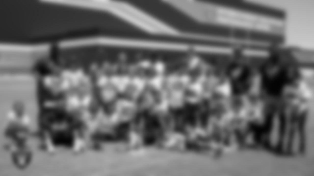 11-year-old and under players and coaches pose for a photo after C.H.A.M.P. Camp at Intermountain Health Performance Center.