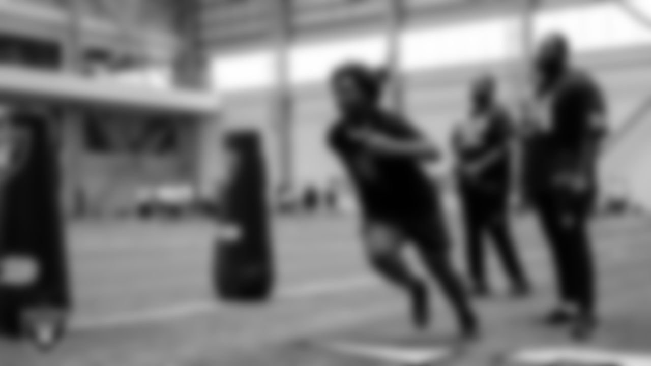 Las Vegas Raiders defensive lineman Neil Farrell Jr. (92) and defensive tackle Matthew Butler (94) work with an athlete as they participate in drills during the ELITE Academy at Las Vegas Raiders Headquarters.