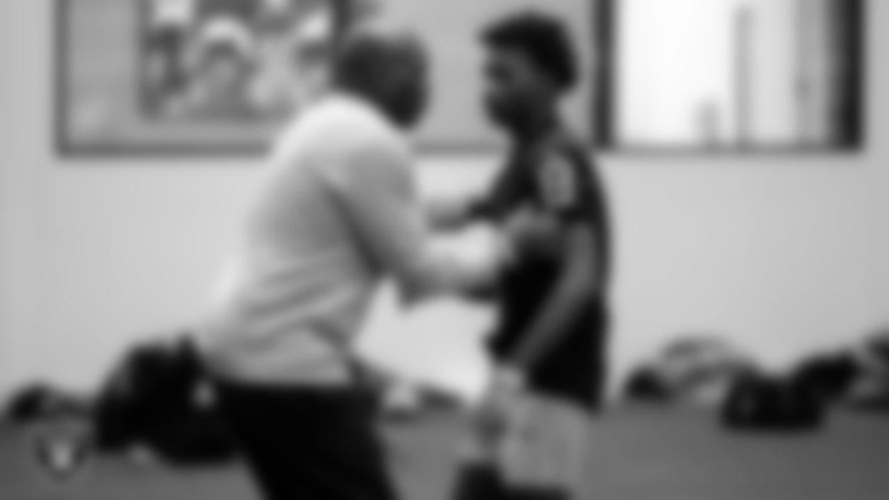 Las Vegas Raiders alumnus Lionel Washington works with an athlete as they participate in drills during the ELITE Academy at the Las Vegas Raiders Headquarters.