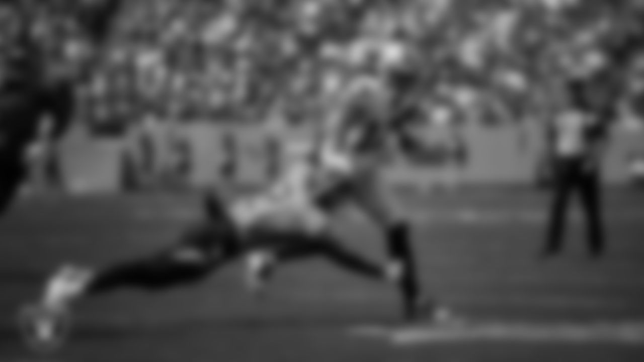 Las Vegas wide receiver Davante Adams (17) stiff arms the defender during the regular season away game against the Tennessee Titans at Nissan Stadium.