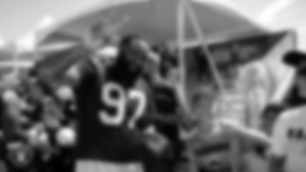 Las Vegas Raiders defensive tackle Nesta Jade Silvera (97) poses for a photo with a fan after practice at 2023 Training Camp at Intermountain Health Performance Center.