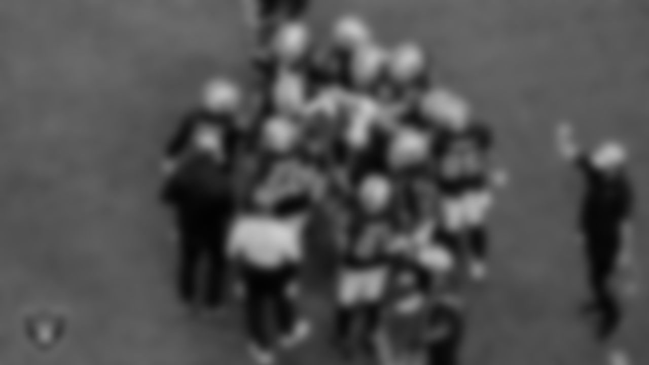 The Las Vegas Raiders huddle during the regular season game against the Tampa Bay Buccaneers at Allegiant Stadium.