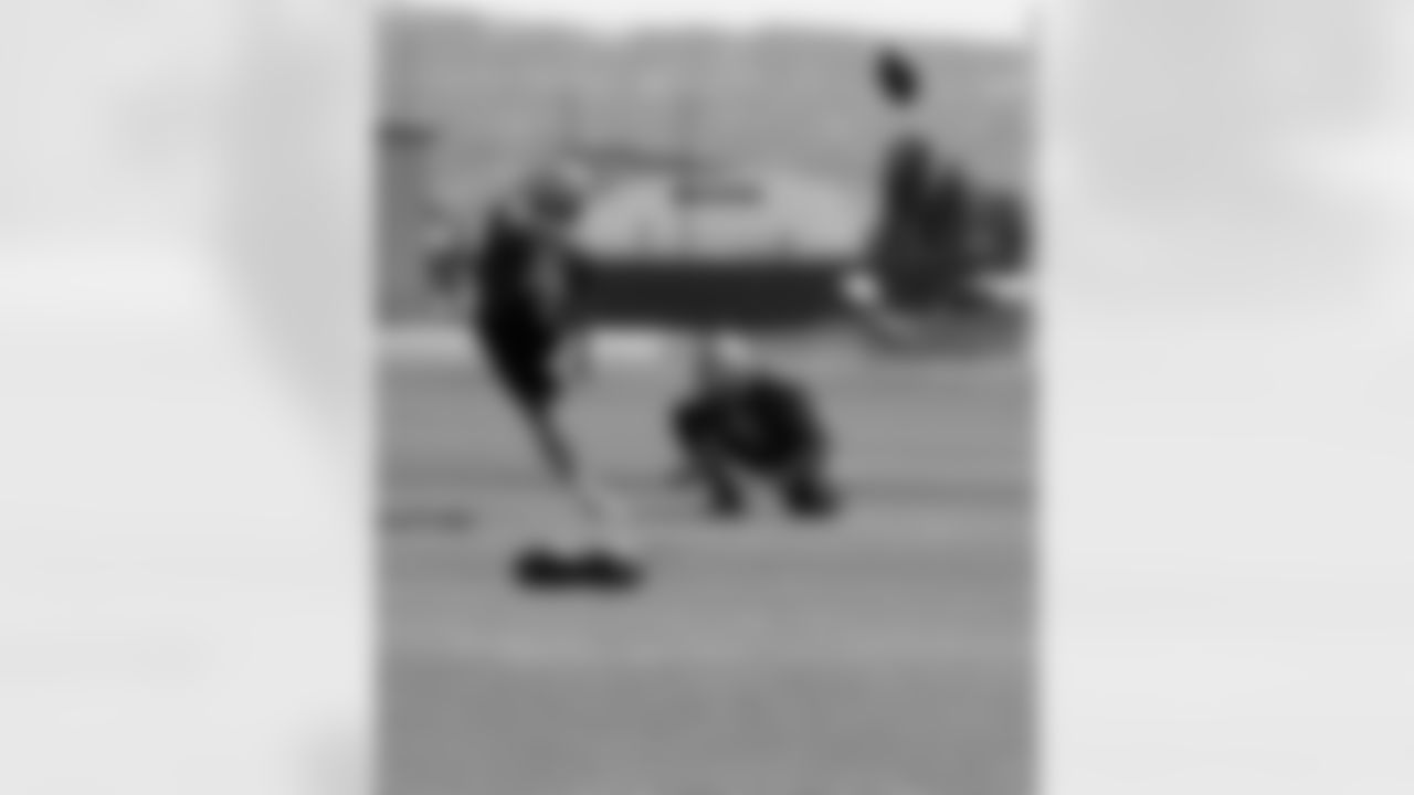 K Sebastian Janikowski kicks out of the hold of P Daniel Zychlinski.