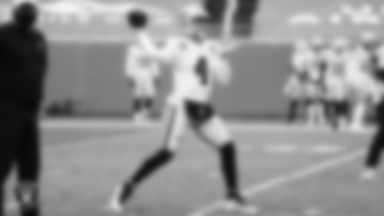 The Raiders warm up before the regular season game against the Denver Broncos at Empower Field at Mile High.