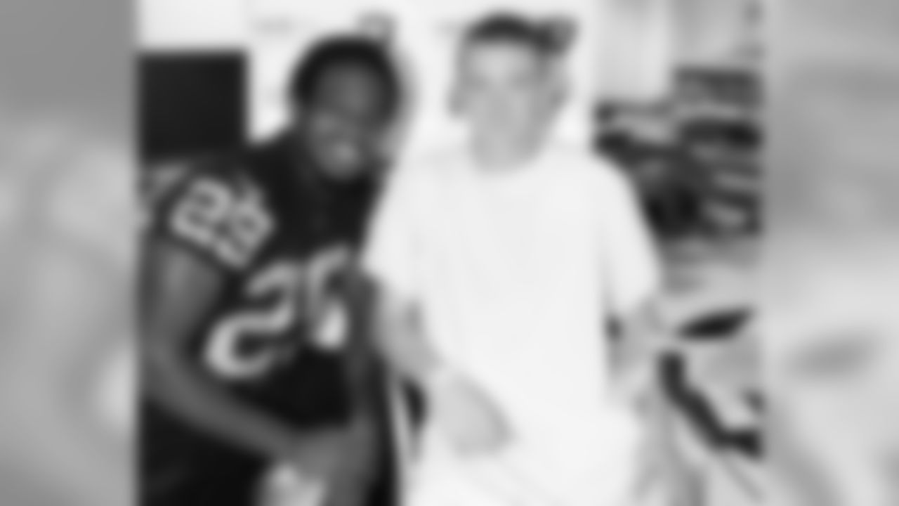DB Brandian Ross poses for a photo with one of the patients at Children's Hospital & Research Center Oakland.