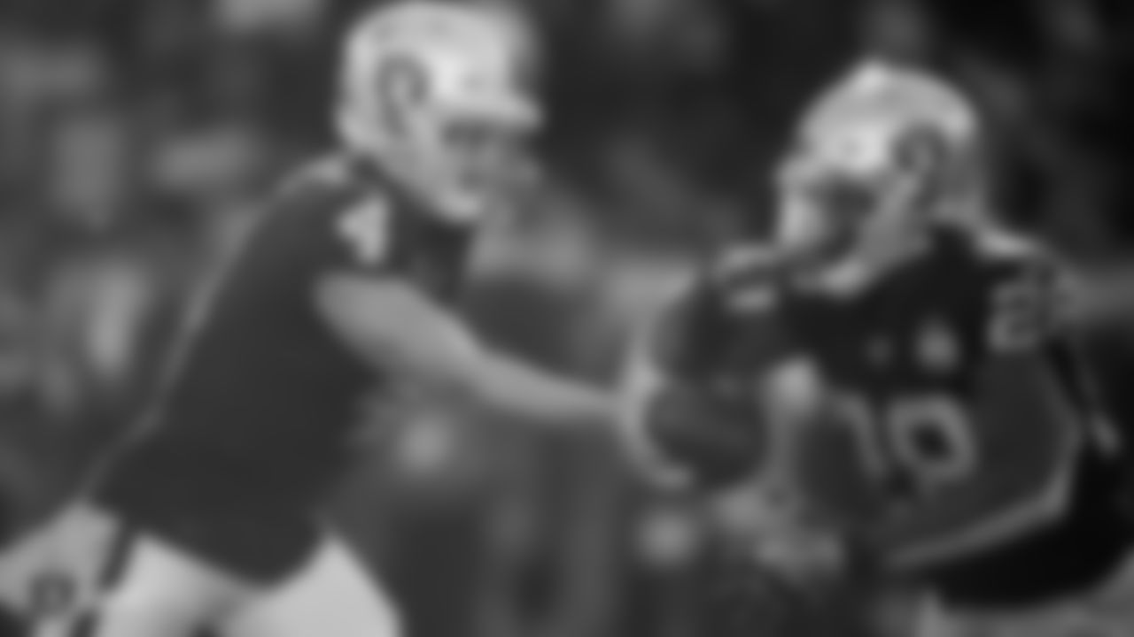 Raiders quarterback Derek Carr (4) hands the ball off to running back Josh Jacobs (28) during the regular season game against the Cincinnati Bengals.