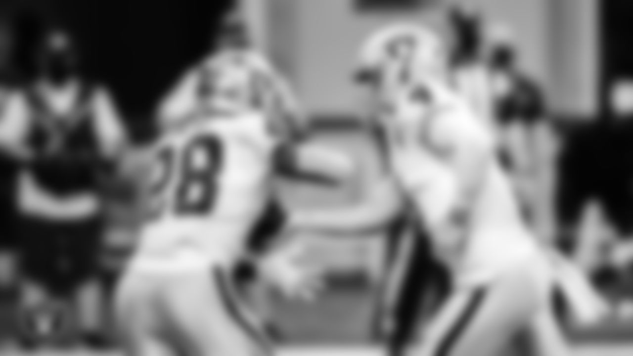 Las Vegas Raiders quarterback Derek Carr (4) hands the ball off to running back Josh Jacobs (28) during the regular season away game against the Atlanta Falcons.