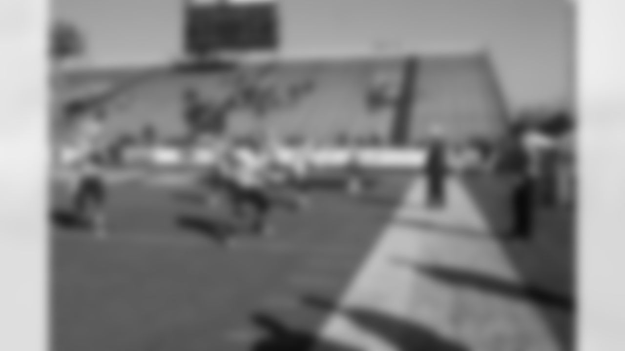 The quarterbacks drop back to pass behind the blocking of the offensive linemen.