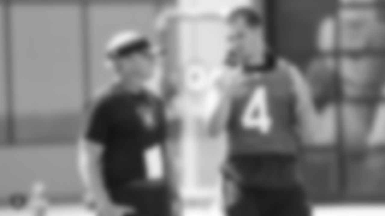 Head coach Jon Gruden talking to Raiders quarterback Derek Carr (4) on the field for practice at the Oakland Raiders Practice Facility, Wednesday, September 12, 2018, in Alameda, California.
