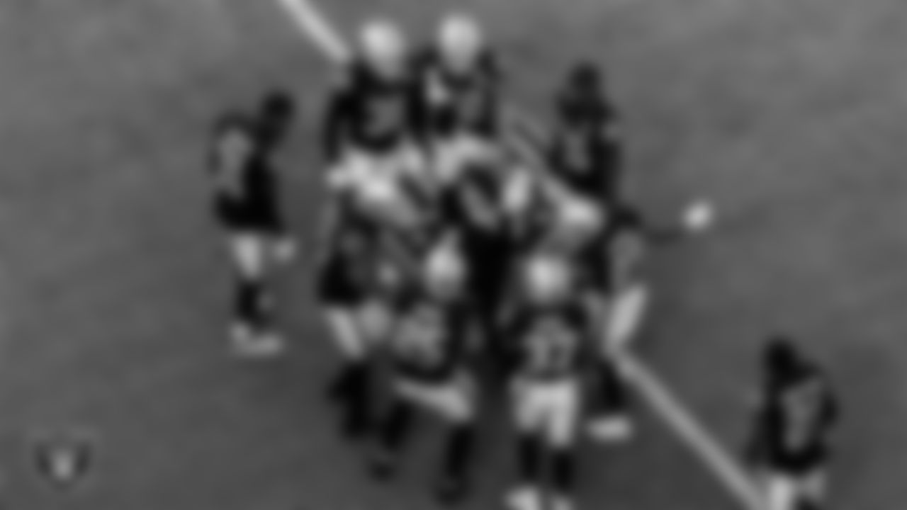 The Las Vegas Raiders defensive backs huddle before the regular season home game against the Tampa Bay Buccaneers.
