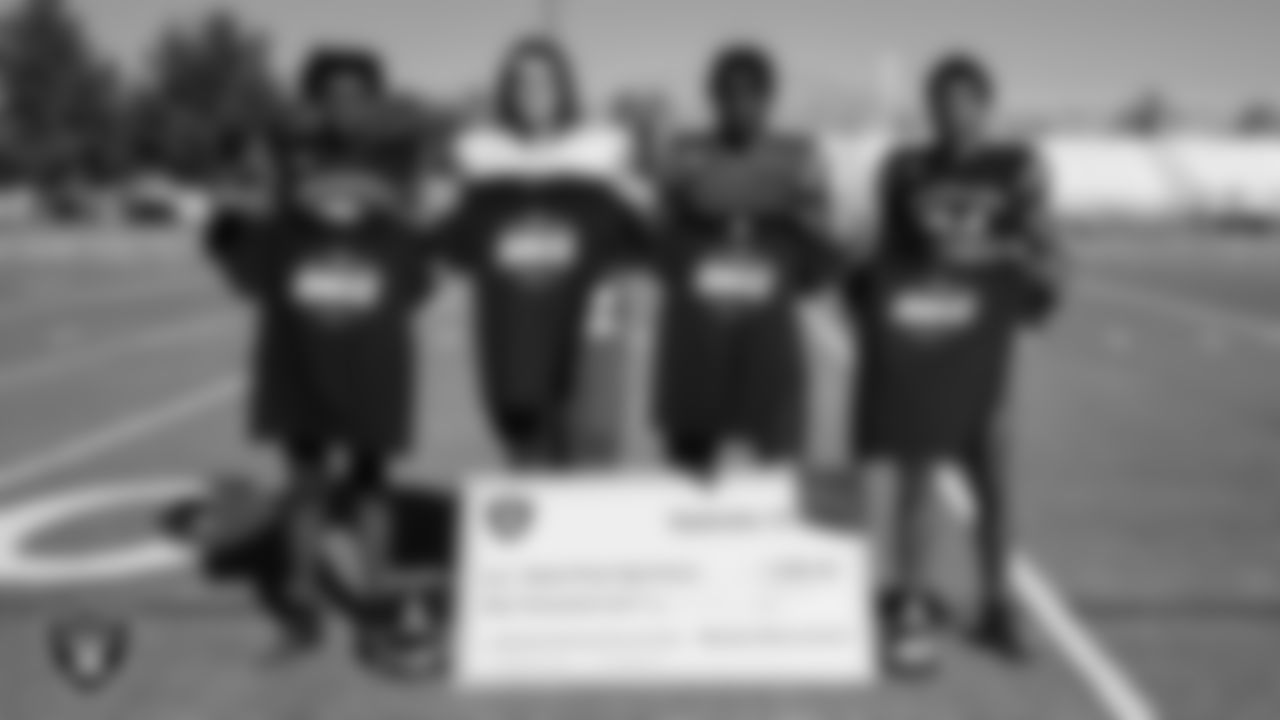 Members of the Desert Pines High School football team show off their High School Football Showcase shirts during practice at Desert Pines High School.