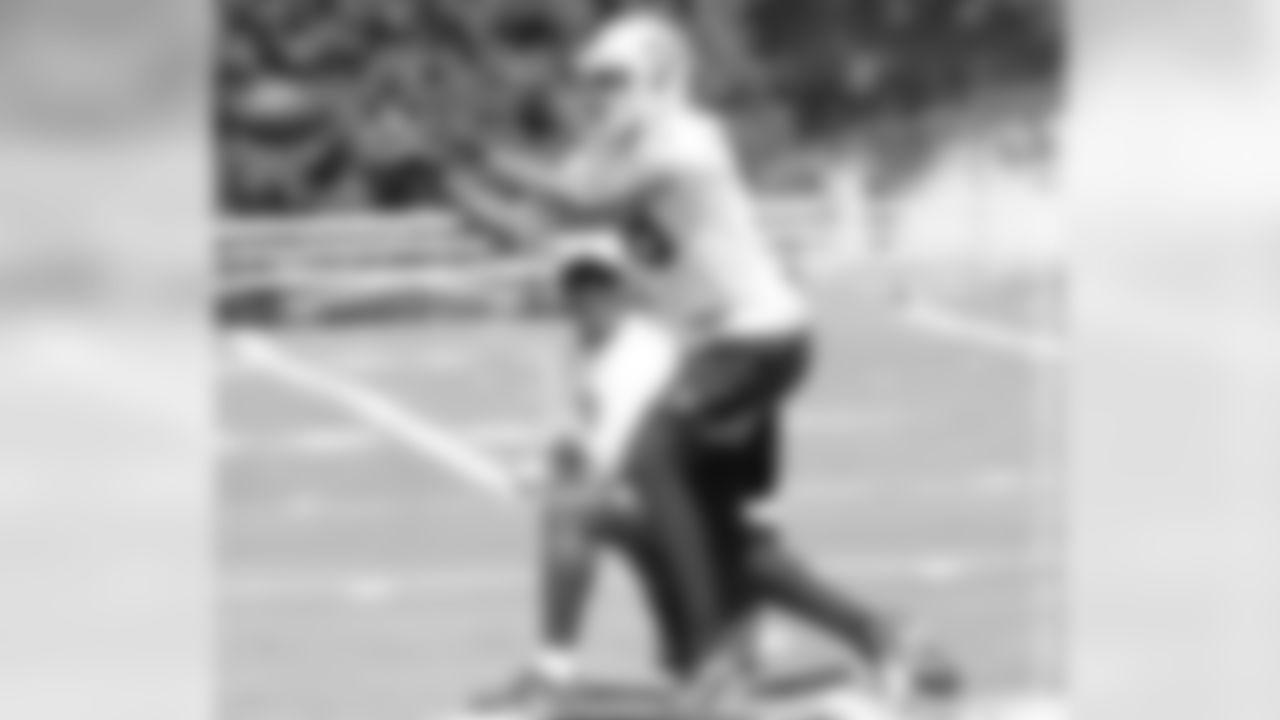 Wide receivers coach Ted Gilmore observes WR Andre Holmes make a catch