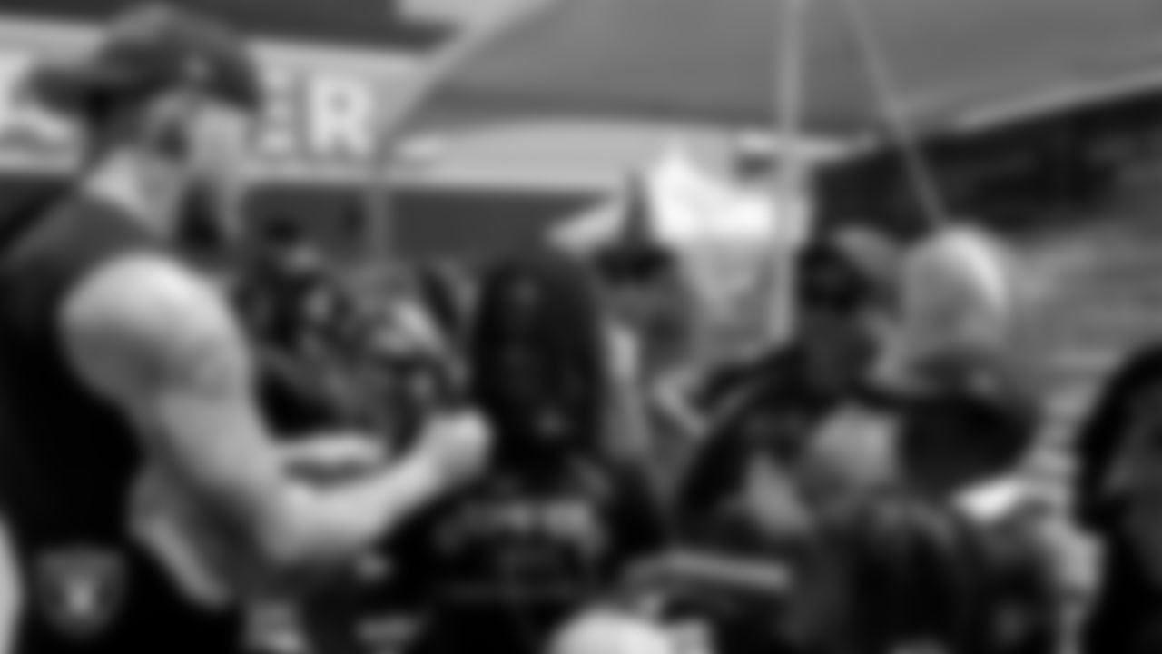 Las Vegas Raiders defensive end Maxx Crosby (98) signs autographs for fans after practice at 2023 Training Camp at Intermountain Health Performance Center.
