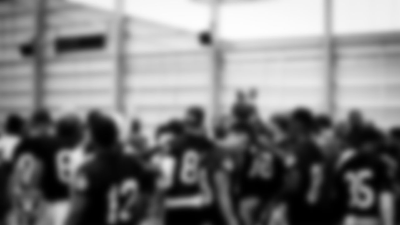 Las Vegas Raiders players and coaches huddle during practice.