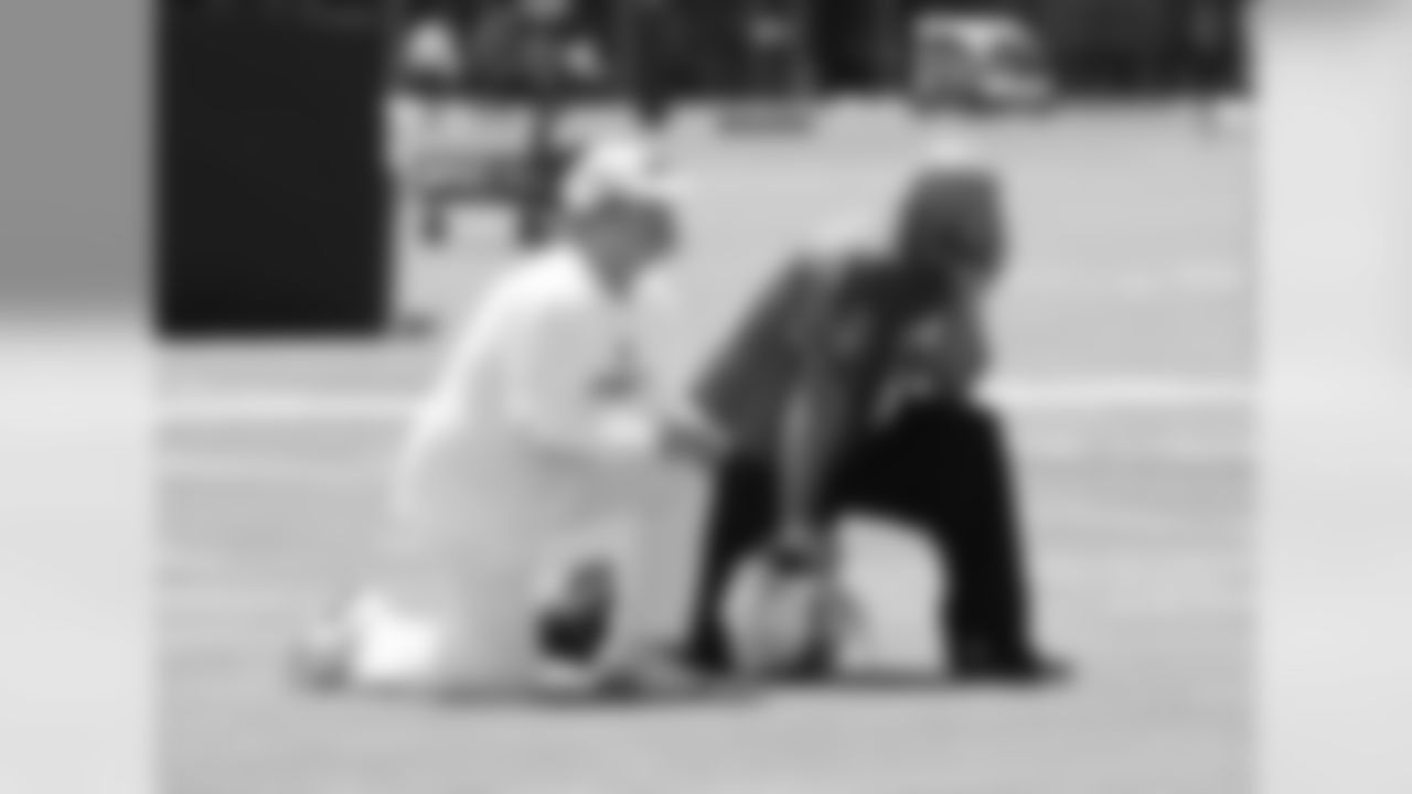 Owner Mark Davis takes a knee with K Sebastian Janikowski.