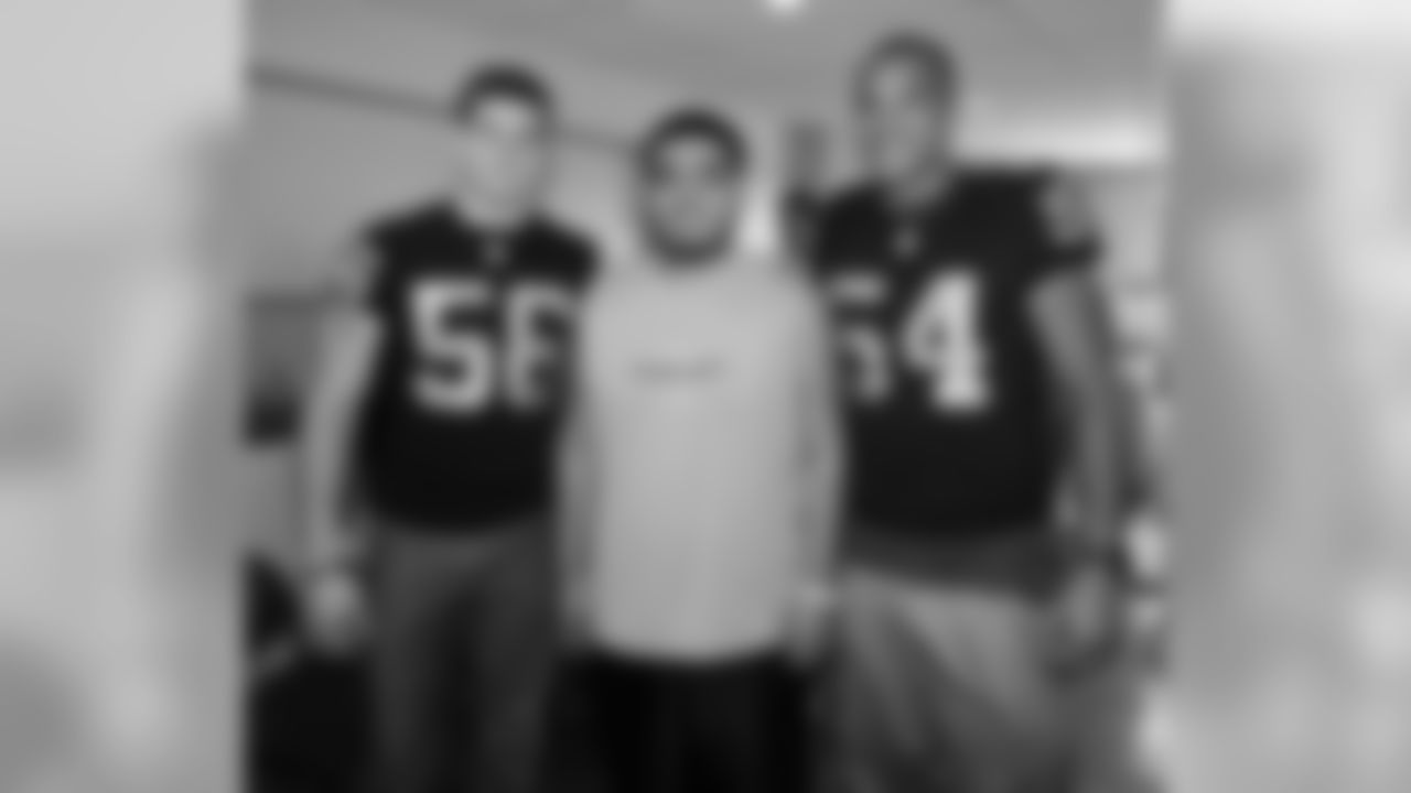 LBs Miles Burris and Vic So'oto pose for a photo with Eric.