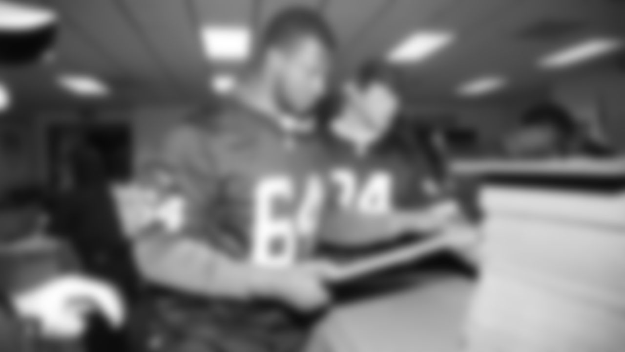 Oakland Raiders linebacker Kyle Wilber (58), tight end Paul Butler (84), tackle Jamar McGloster (64), defensive tackle Clinton McDonald (97), linebacker Shilique Calhoun (91), long snapper Andrew DePaola (48), the Raiderettes, and the Raiders Front Office in Alameda build care packages for victims of the Norther California Fires, Tuesday, November 20, 2018, in Alameda, California.
